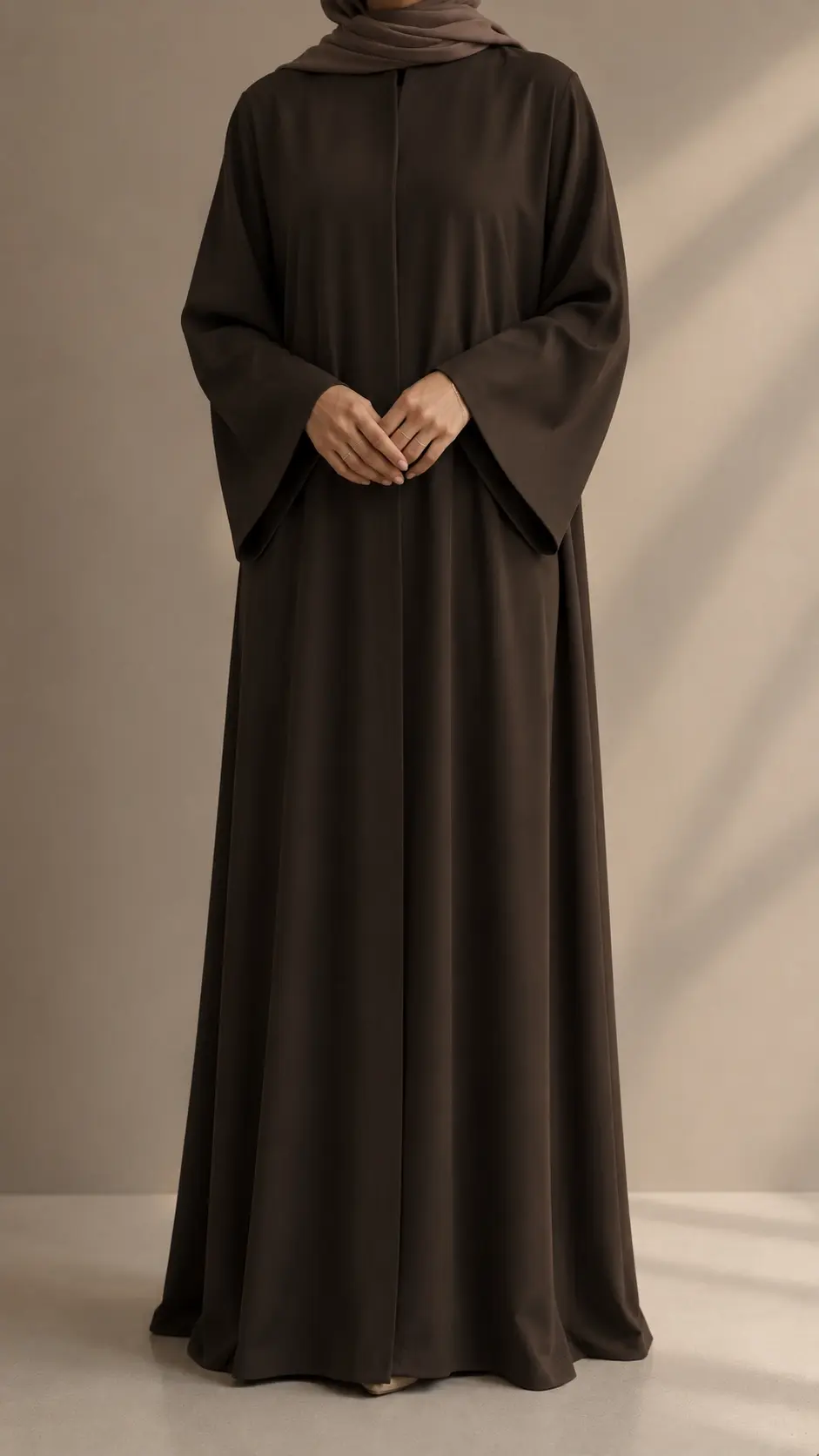 Elegant brown open abaya with wide sleeves and matching hijab worn by a model.