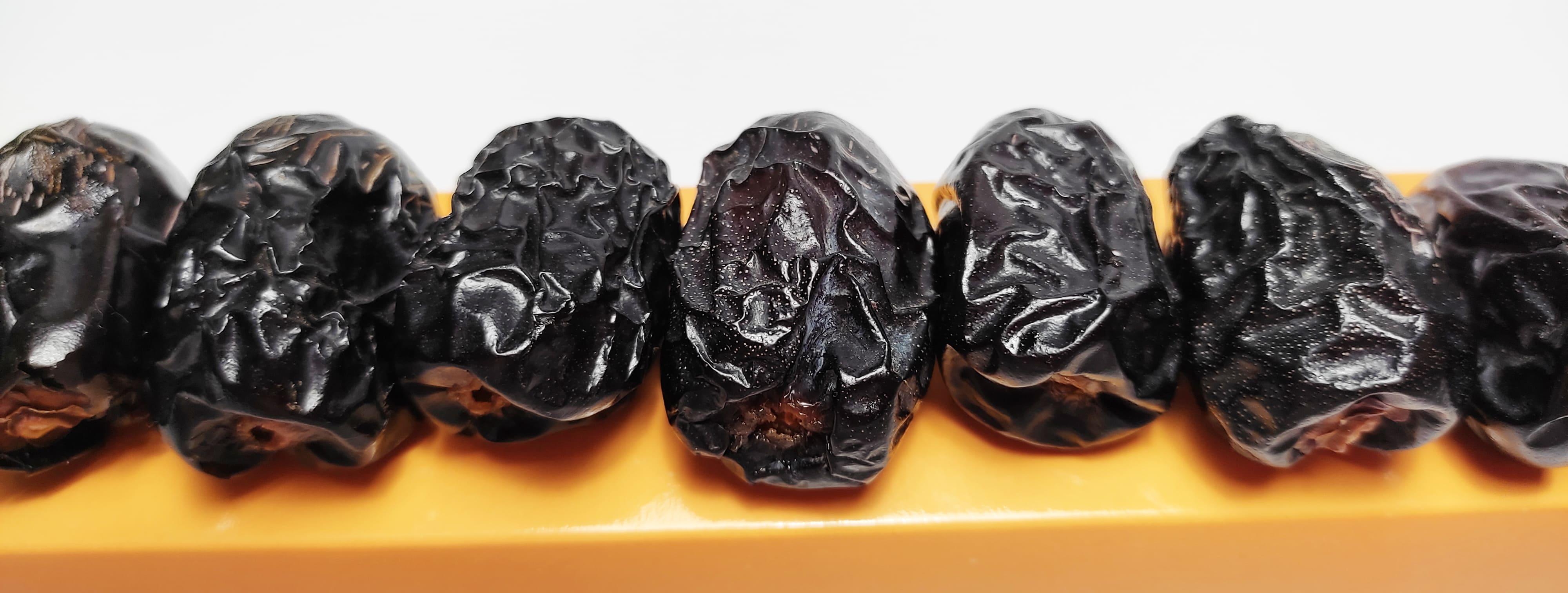 Dried premium Ajwa Dates placed on a box